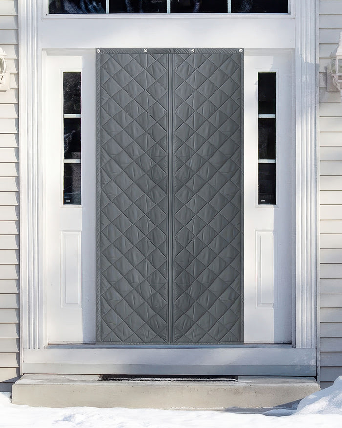 Gray custom quilted magnetic door curtain on a white front door with sidelights, providing thermal insulation and privacy during winter.