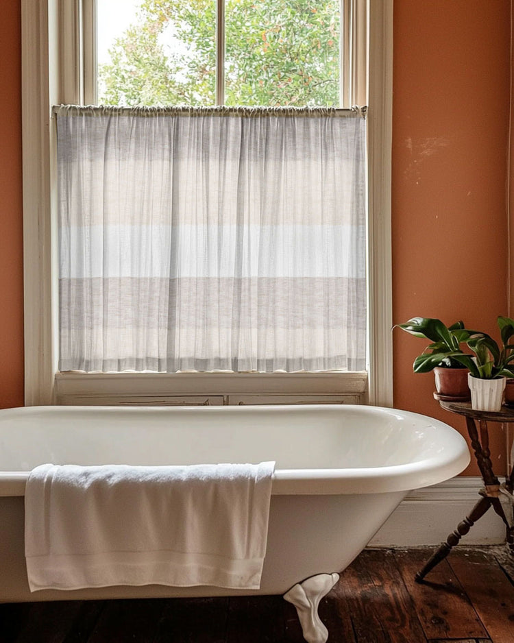 Raw Linen Blend striped patterned semi-sheer custom cafe curtain, neutral tones, offers privacy over a bathroom window & clawfoot tub.