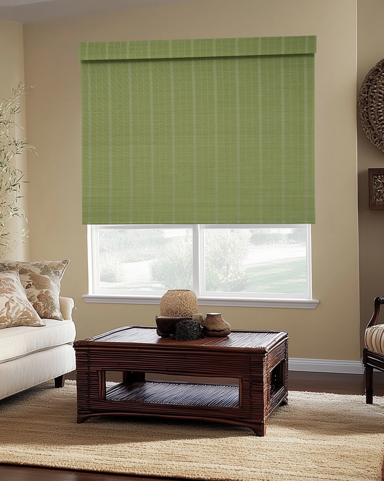 Green Hana Bamboo Woven Shade, a custom window treatment, partially covering a window for light control and privacy in a stylish living room.