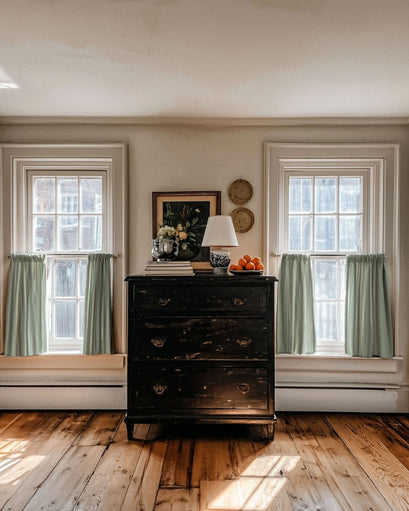 Elegant Sally Linen Blend custom cafe curtains in sage green on two windows, enhancing light control & privacy in a sophisticated home.