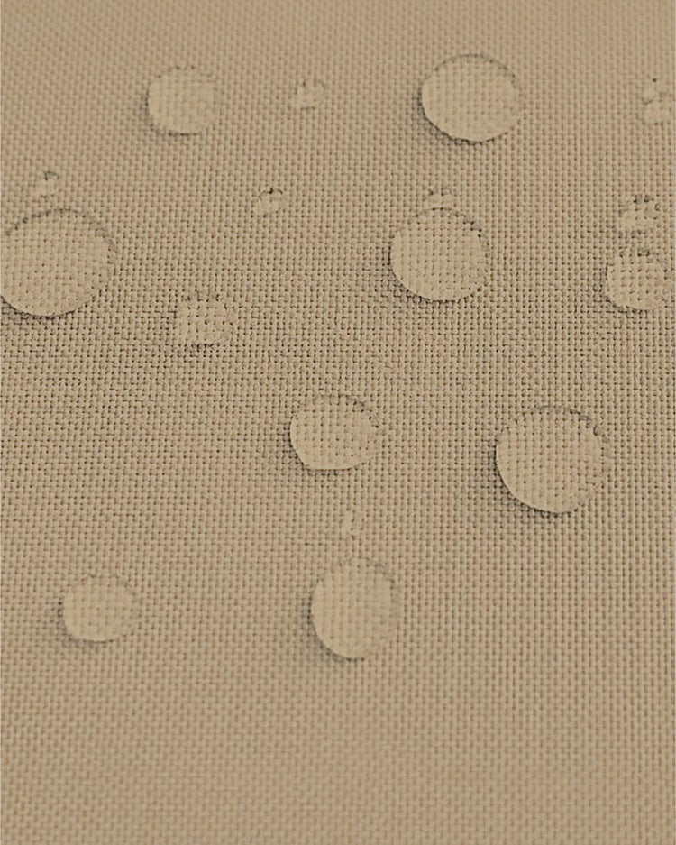 Beige UVShield outdoor sun shade fabric swatch showing water resistance with beaded droplets.