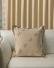 Arden textured yarn stitched throw pillowcase with 'X' embroidery on a sofa, complementing custom pleated natural linen drapery.