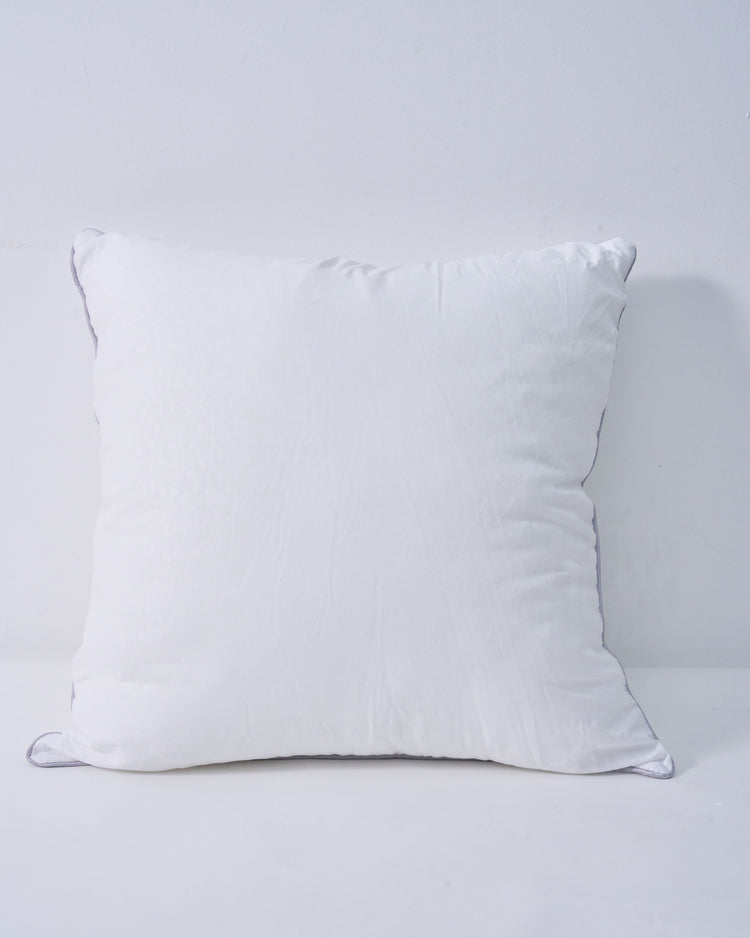 Plush white feather throw pillow insert with subtle leaf pattern and grey piping, for a supportive, naturally full look.