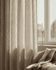 Interlace linen blend patterned custom curtain with a beige geometric trellis design hanging in a bright living room.