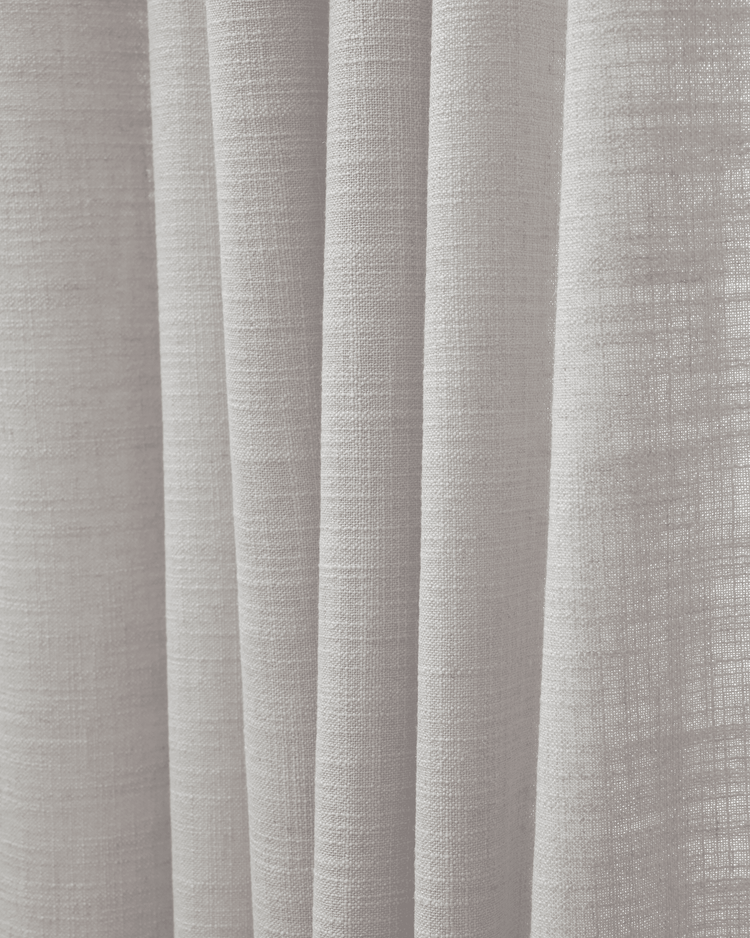 Detailed view of Cassie linen blend fabric in a light shade, highlighting its exquisite weave and drapery potential for custom window treatments.