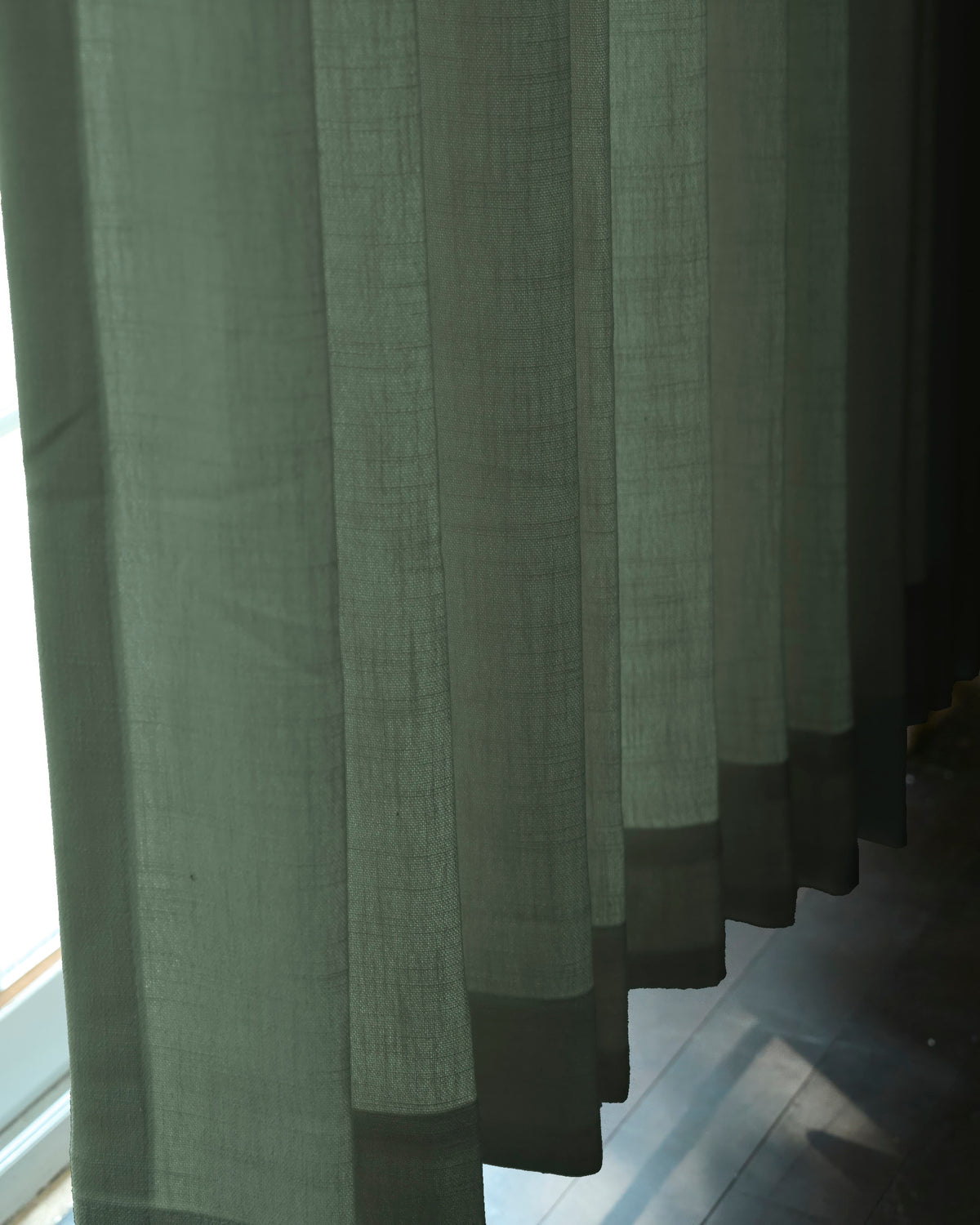Cassie green linen blend custom curtain with elegant pleats, showcasing the fabric's natural texture and how it filters soft light.