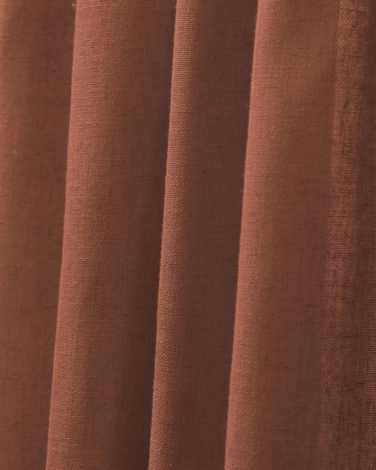 Close-up of Chloe Linen Look Burlap Textured Sheer Curtain in warm terracotta, showing folded fabric detail & weave.