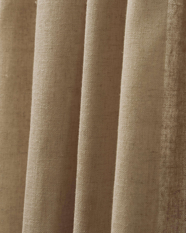Close-up of a natural beige Chloe Linen Look Sheer Curtain, highlighting its distinctive burlap texture and elegant folds.