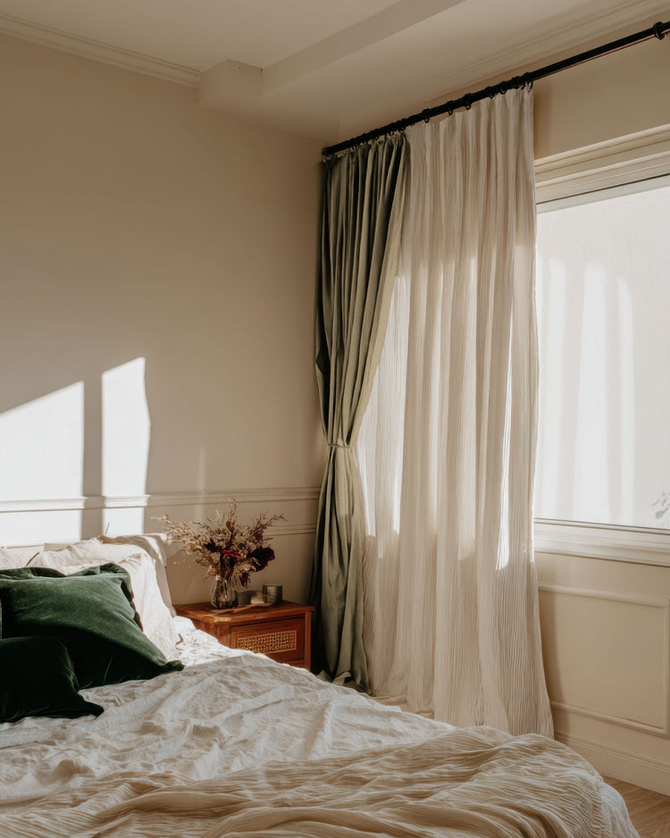 Sunlit bedroom with a layered custom window treatment: Chloe 100% Blackout Linen Look Burlap Textured Sheer Curtain and a green drape.