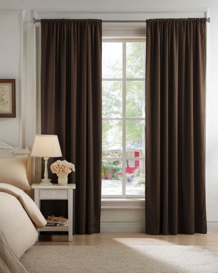 Full-length chocolate brown luxury velvet blackout custom curtains in a bedroom, ensuring complete privacy & optimal light control. Perfect for sophisticated home decor.