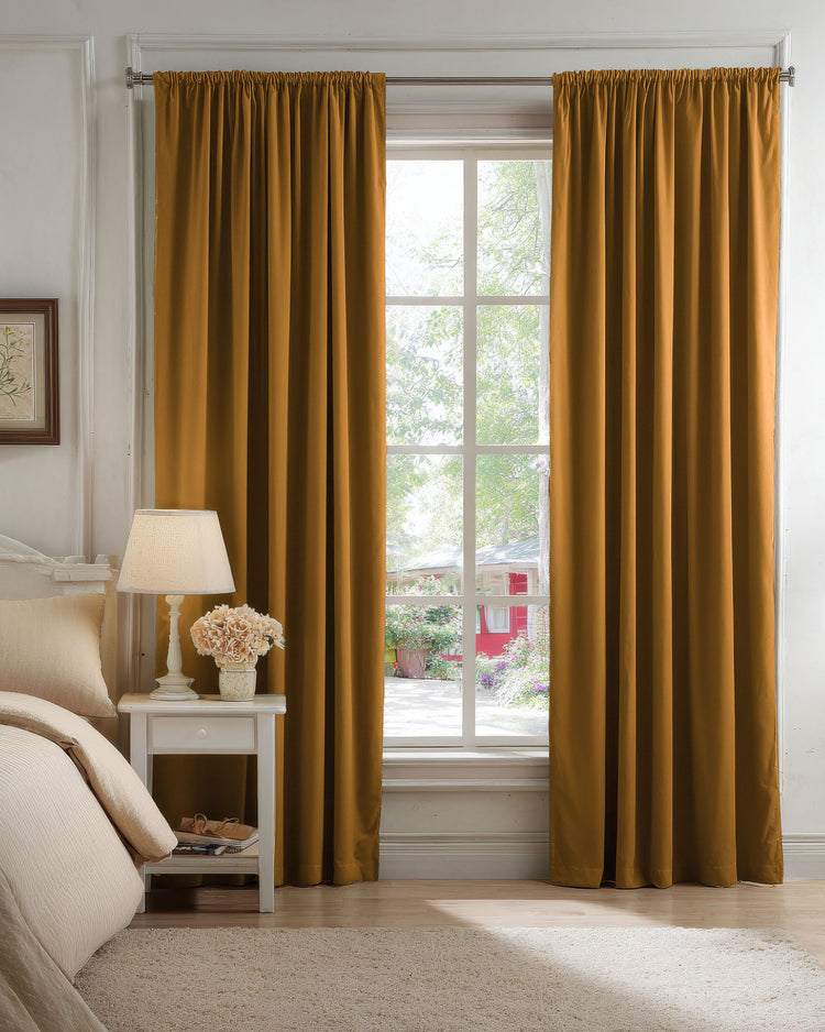 Classic custom gold velvet blackout curtains with a gathered rod pocket header, perfectly framing a bedroom window.