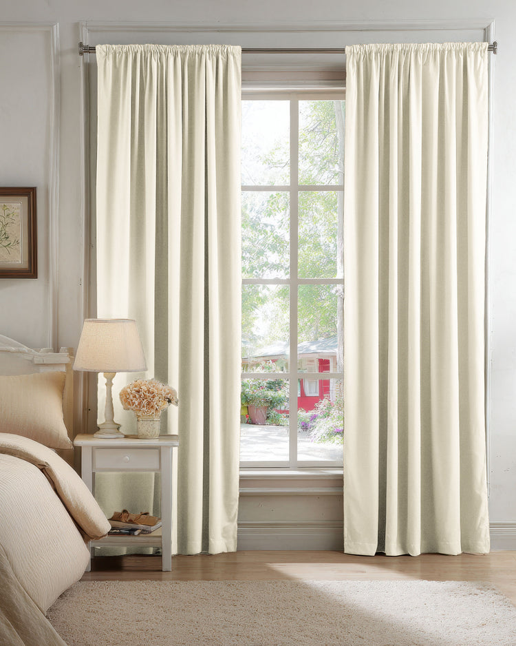 Classic cream velvet blackout custom curtains with gathered header, open on a bedroom window, showcasing plush texture & luxury.