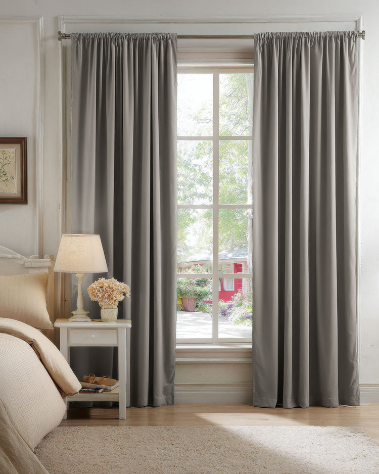 Made-to-measure classic grey 100% blackout velvet custom curtains in a bedroom, providing light control and sophisticated decor.