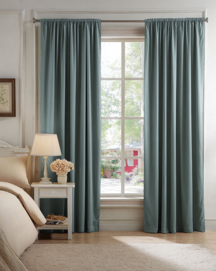 Petrol blue velvet blackout custom curtains with gathered header framing a bedroom window for light control and privacy.