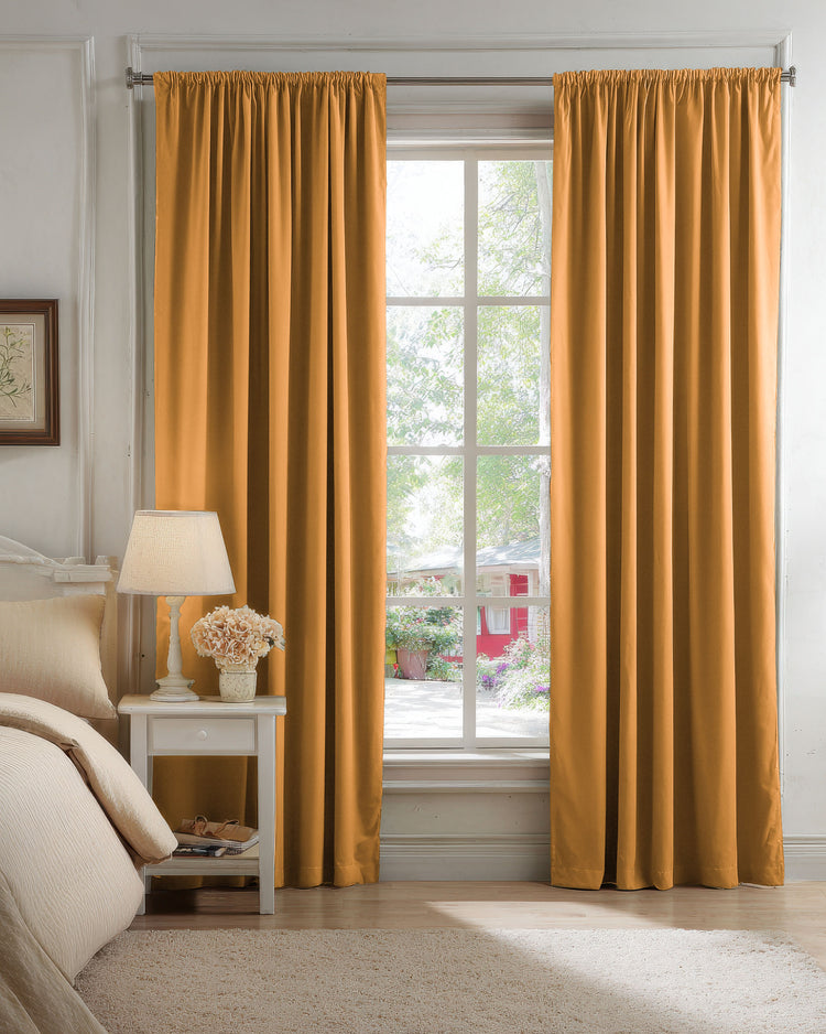 Golden velvet blackout custom curtains with rod pocket header in a bright bedroom, offering superior light control and privacy.