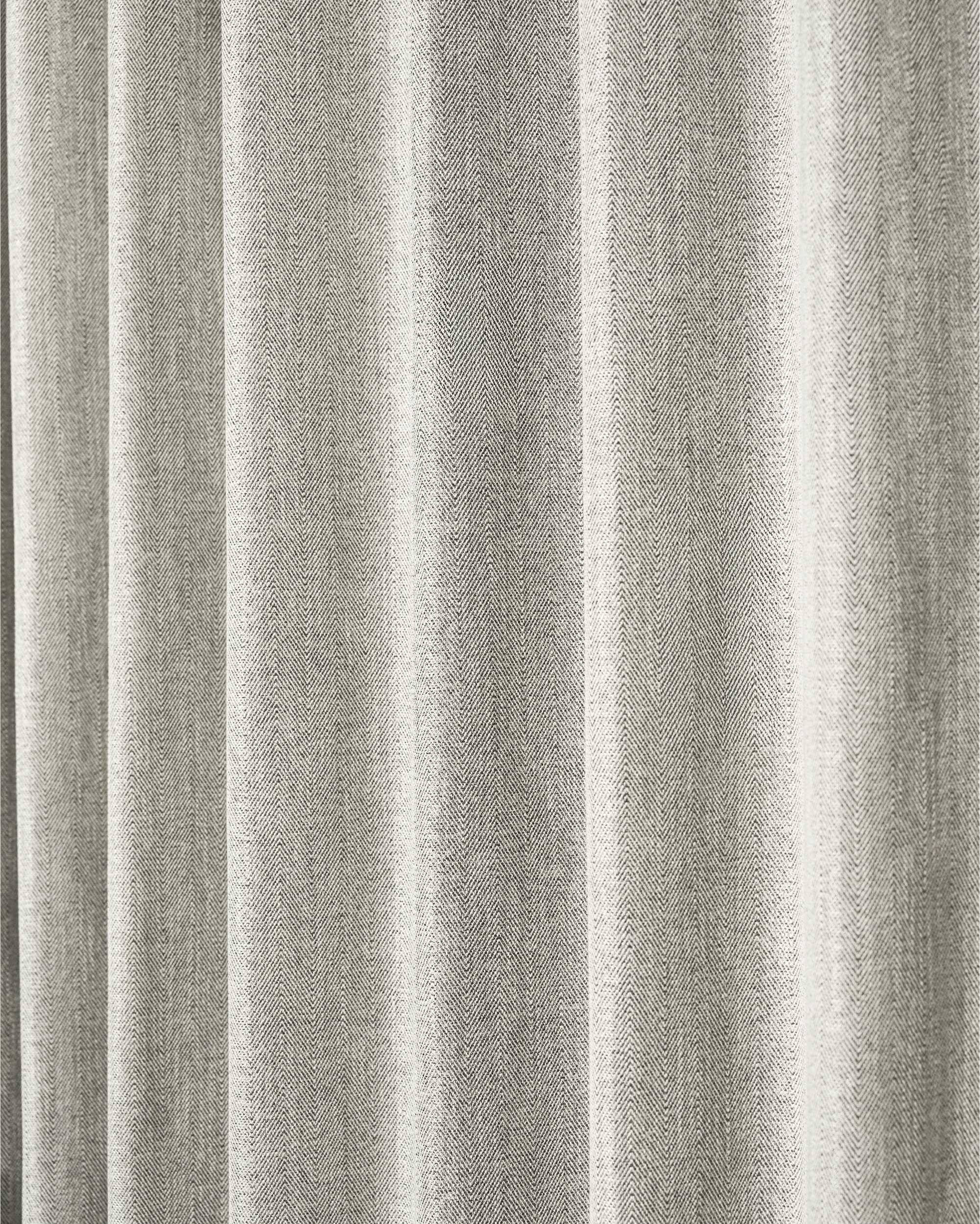 Cleo textured custom curtain in grey, showcasing its detailed herringbone weave fabric with elegant drapes for sophisticated window treatments.