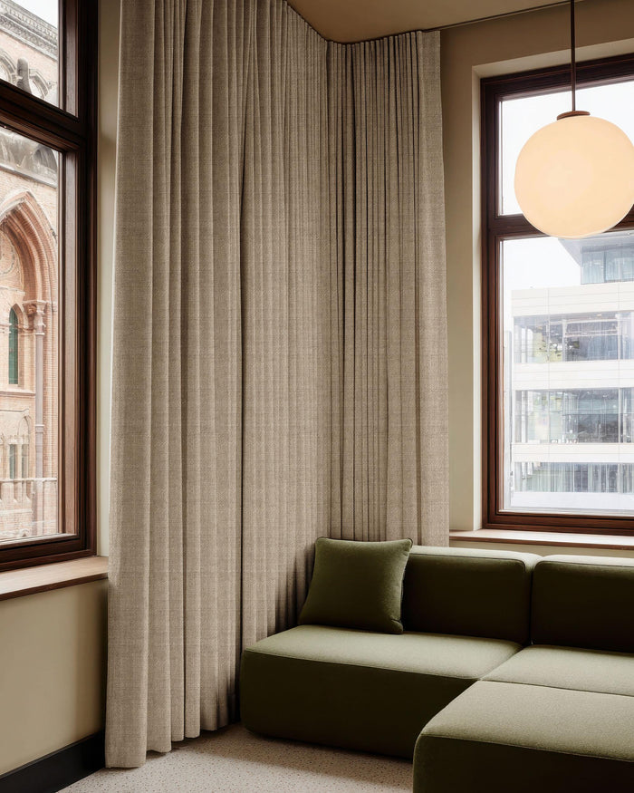 Beige Cracovia 100% blackout linen blend textured custom curtains floor-to-ceiling in a modern living room corner.