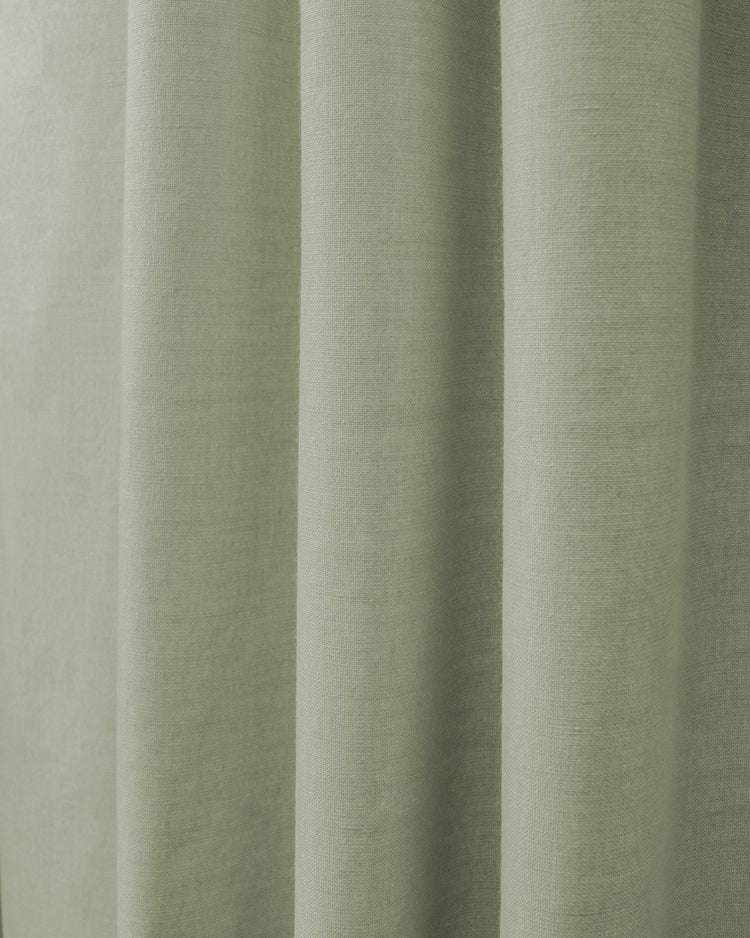Detailed view of Cronin linen look blackout custom curtain in a soft sage green, showcasing its textured fabric.