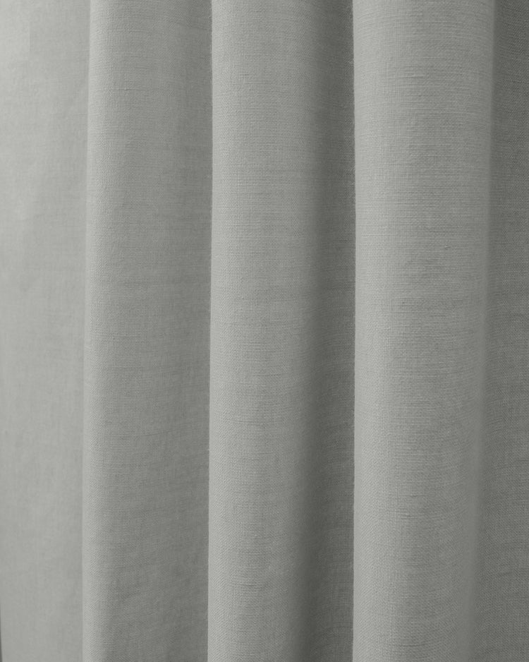 Grey Cronin linen look blackout custom curtain fabric showing its weave texture and soft vertical folds.