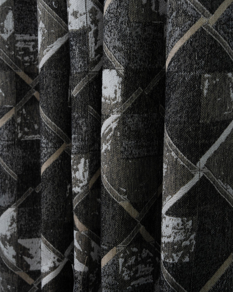Dark grey deconstructed geometric patterned custom curtain. Close-up of heavyweight linen & wool blend fabric with white & beige accents.