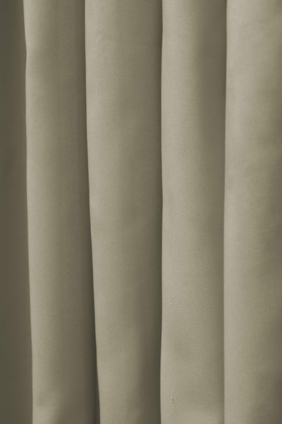 Light olive FadeShield™ canvas waterproof custom outdoor curtain fabric with visible weave and soft drapes for window treatments.