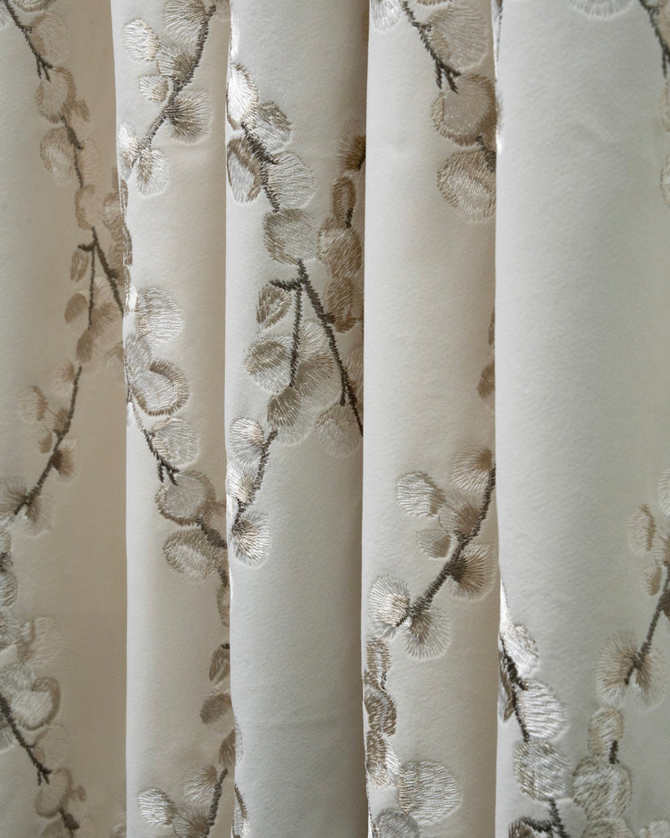 Flora Velvet custom luxury velvet curtain. Delicate light gold embroidered floral leaf pattern on soft beige drapery.
