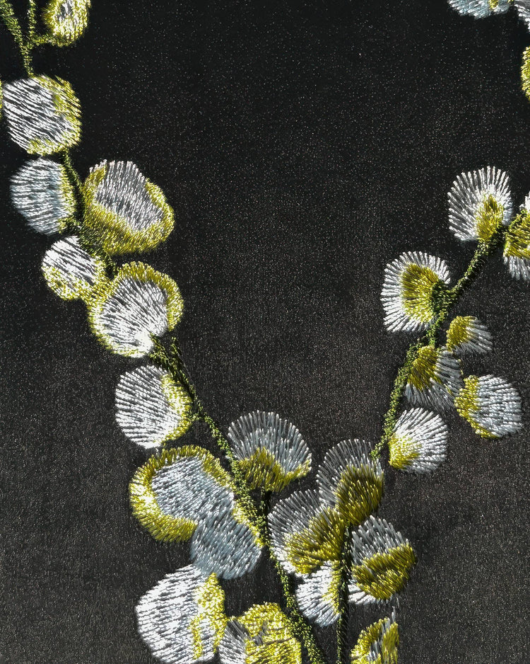 Flora Velvet custom drapery close-up: intricate silver and green embroidered floral pattern on luxurious velvet.
