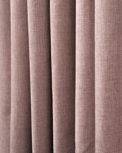 Close-up of Florence 100% blackout custom curtain, showcasing its heavyweight woven texture in a soft, dusty rose hue.