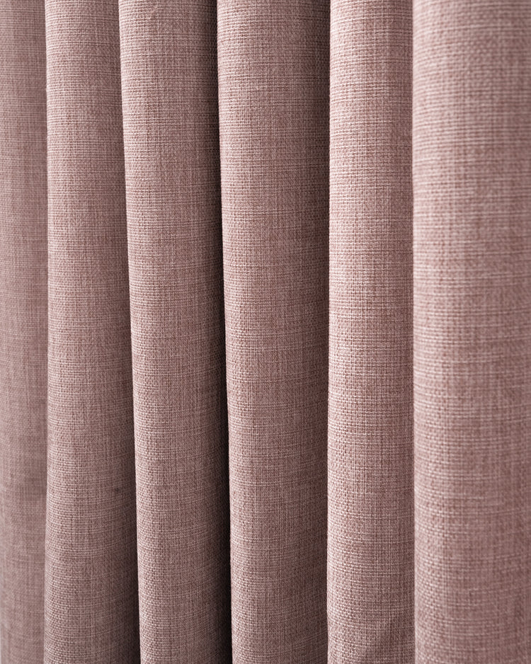 Close-up of Florence 100% blackout custom curtain, showcasing its heavyweight woven texture in a soft, dusty rose hue.