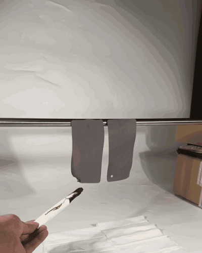 Burn test: ordinary curtain fabric keeps burning and drips molten material after the flame is removed, beside an untouched Frisian flame retardant panel