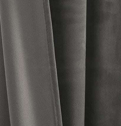 Close-up of rich dark grey luxury velvet custom curtain fabric, showcasing its soft pile and elegant drape.