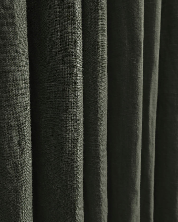 Close-up of deep olive green 100% linen custom curtains, highlighting the natural textured fabric and elegant drapery folds.