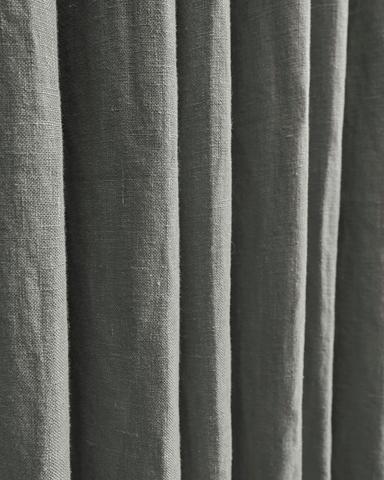 Close-up of luxurious grey Helena 100% linen custom curtains, detailing the natural fabric weave and elegant folds.
