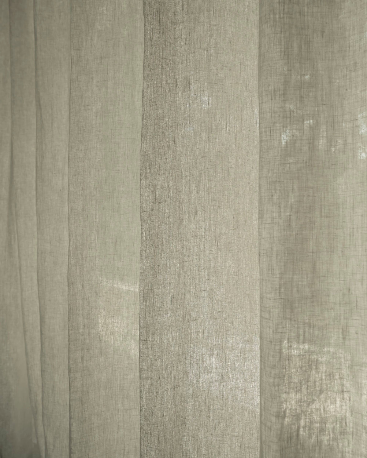 Close-up of Helena 100% pure linen custom curtains, showcasing the sheer texture and how light softly filters through the elegant fabric.