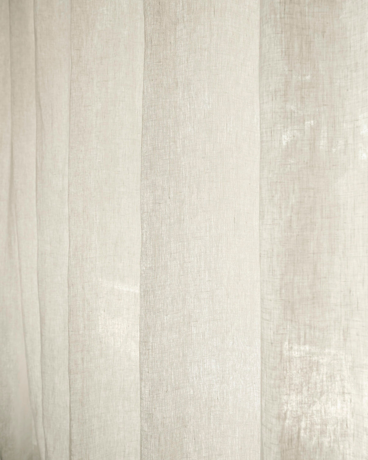 Close-up of Helena 100% linen custom curtain fabric, highlighting natural texture and soft folds for tailored window treatments.