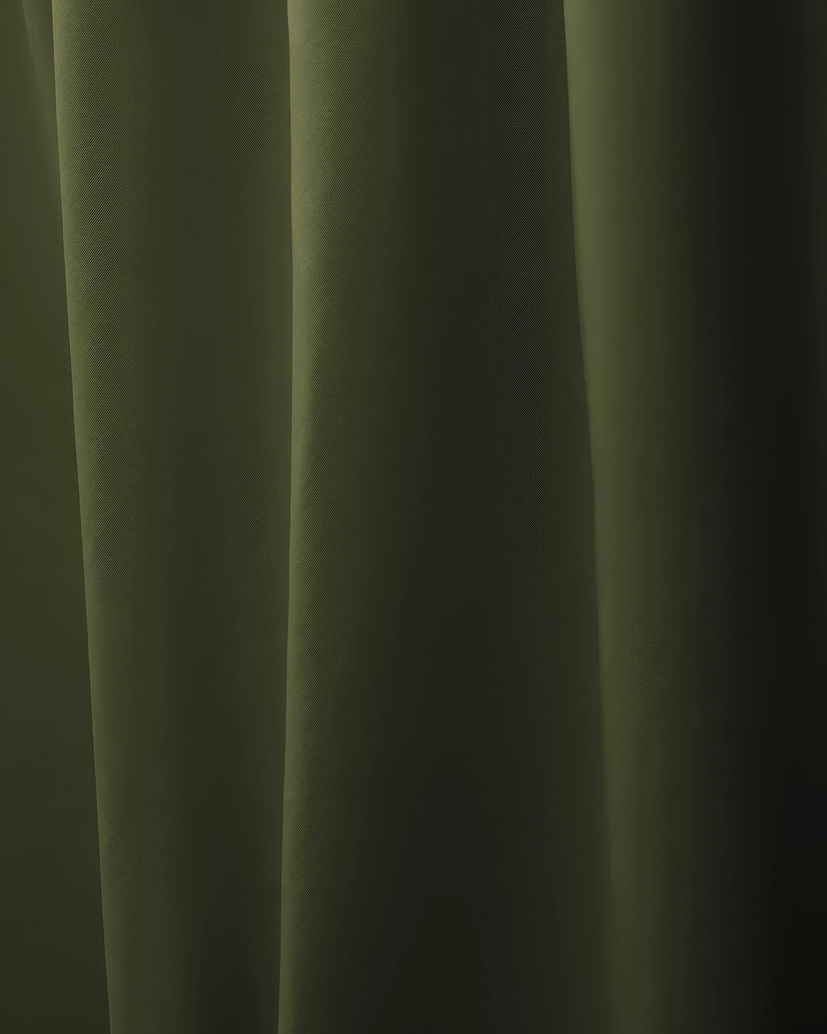 Dark olive green custom curtain, draped with elegant folds, showcasing the premium fabric for sophisticated window treatments.