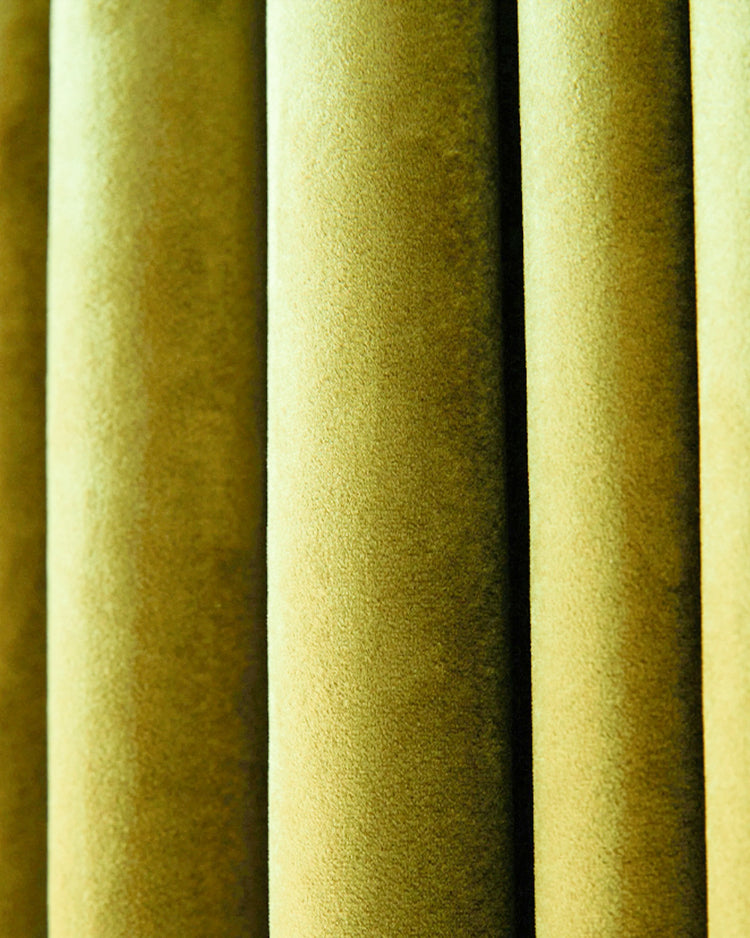 Soft, plush Moonlit Velvet custom curtain fabric, detailed texture in a subtle golden hue, showcasing elegant vertical folds.