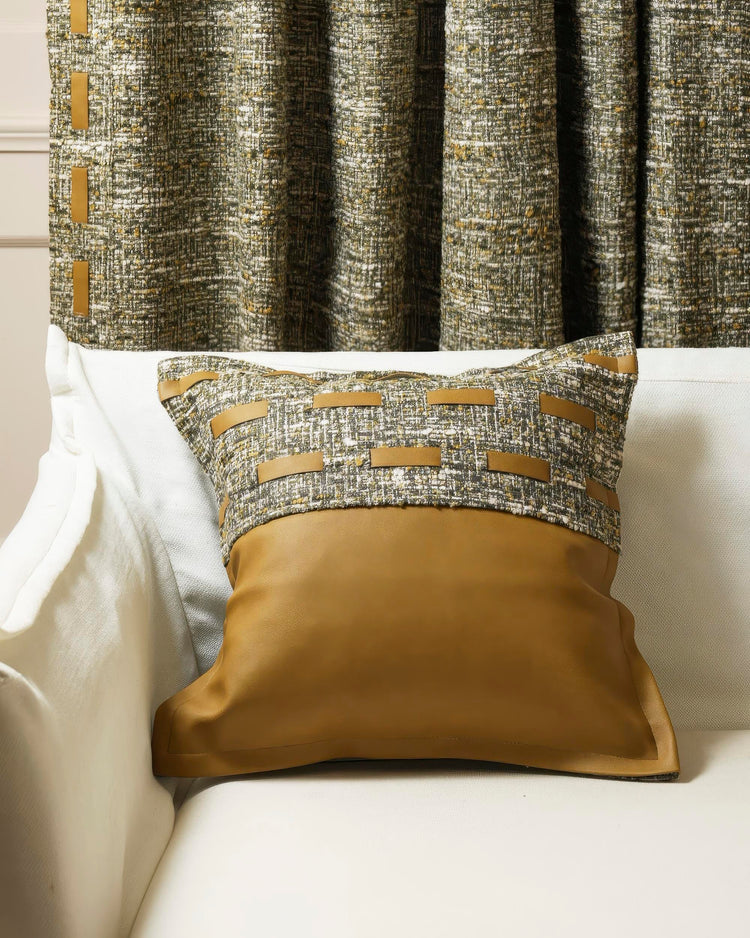Juliette Textured Faux Leather Throw Pillowcase on a white sofa, with tan faux leather base and cream-green woven top with straps.
