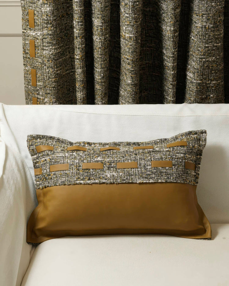Juliette textured leather lumbar pillowcase with green-gold woven fabric top & brown leather tabs, on sofa with matching custom drapes.