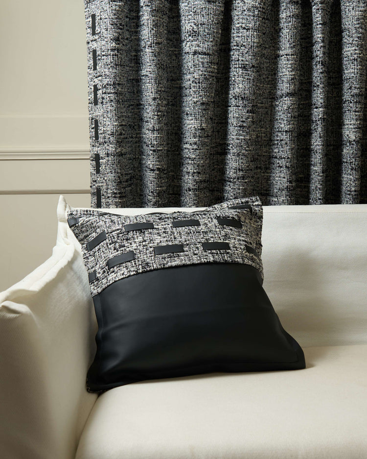 Juliette textured faux leather throw pillowcase on sofa with matching custom drapery, featuring tweed fabric & elegant black accents.