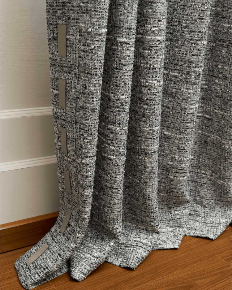 Textured Juliette custom wool blend curtain in gray with white flecks, featuring elegant vertical light trim along the border. Premium drapery.
