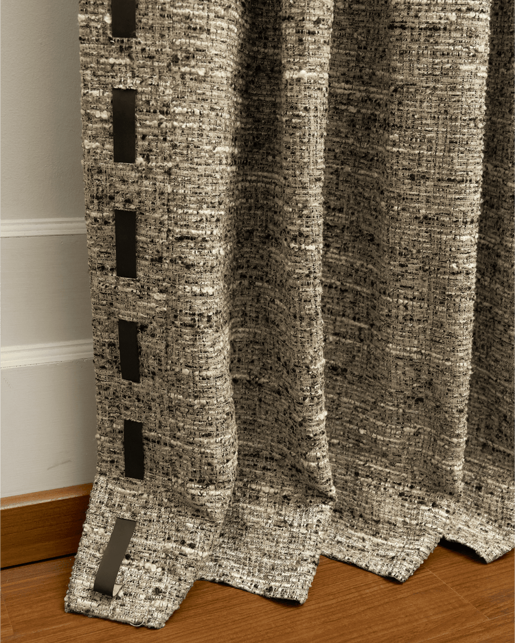 Juliette wool blend textured custom curtain close-up, showing rich fabric weave, elegant black vertical trim, and soft drape on floor.
