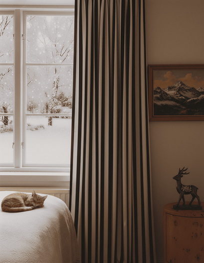 Liam Striped Linen Blend custom curtain with vertical dark & light stripes, framing a snowy window in a cozy bedroom.
