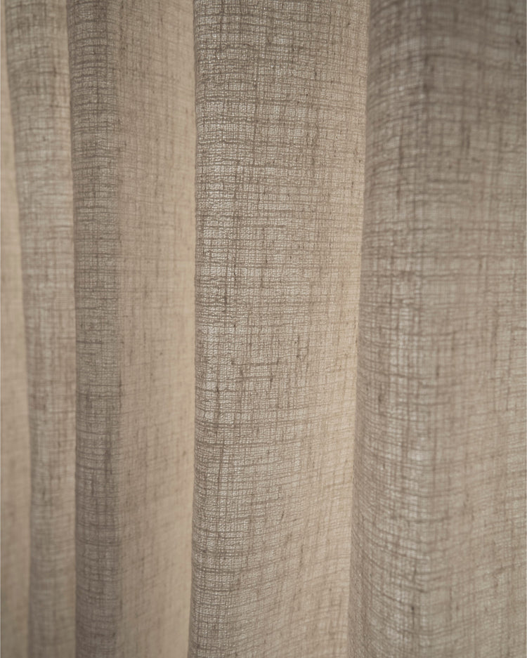 Close-up of elegant beige Luna linen blend textured fabric with visible vertical folds, showcasing the intricate weave for custom drapery.