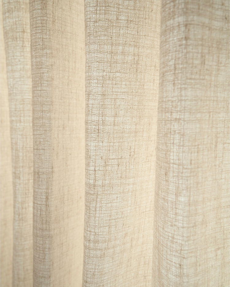 Close-up Luna Linen Blend textured fabric swatch in natural beige, showcasing its rich, coarse weave and elegant light filtering.