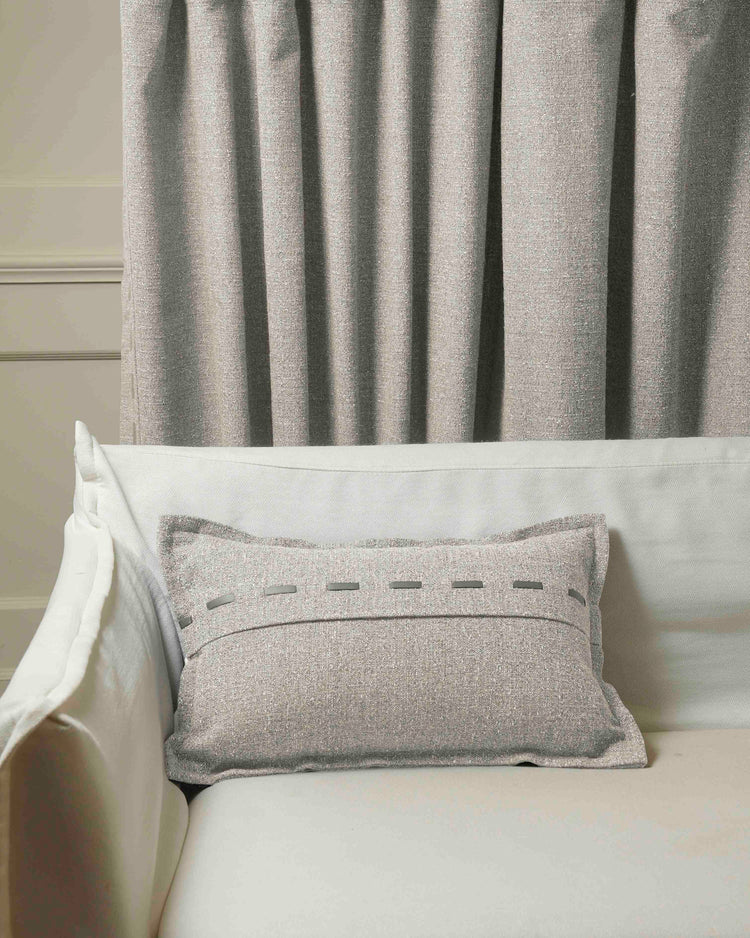 Light gray Luna Linen Blend Faux Leather Laced Lumbar Pillowcase on a white sofa, styled with coordinating high-end drapery.