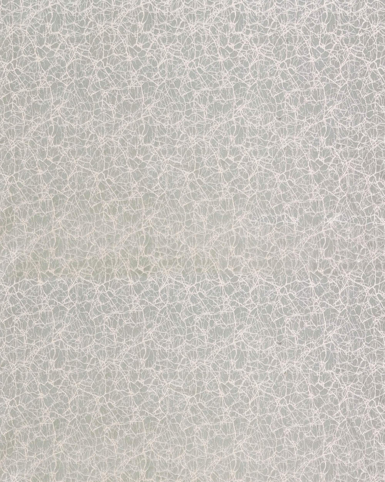 Close-up of Luxor custom curtain fabric: light grey velvet with intricate silver-white foil printed abstract pattern.