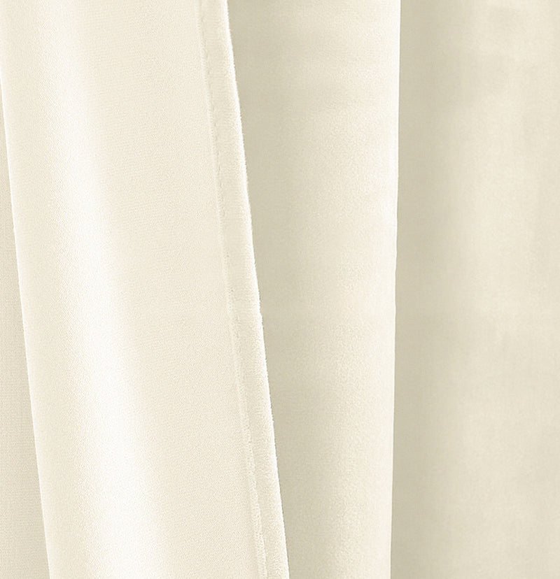 Close-up of luxurious cream velvet custom curtain fabric, showcasing its soft texture and elegant drape.