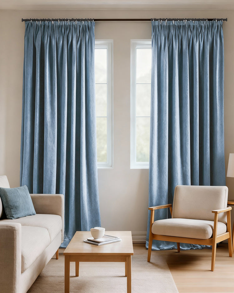 Custom sky blue heavyweight velvet 100% blackout curtains with pleated headers, perfectly balancing privacy and light control.