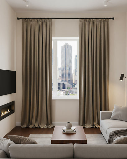 Floor-to-ceiling brown velvet blackout custom curtains in a modern living room, demonstrating luxurious thermal and soundproof drapery.
